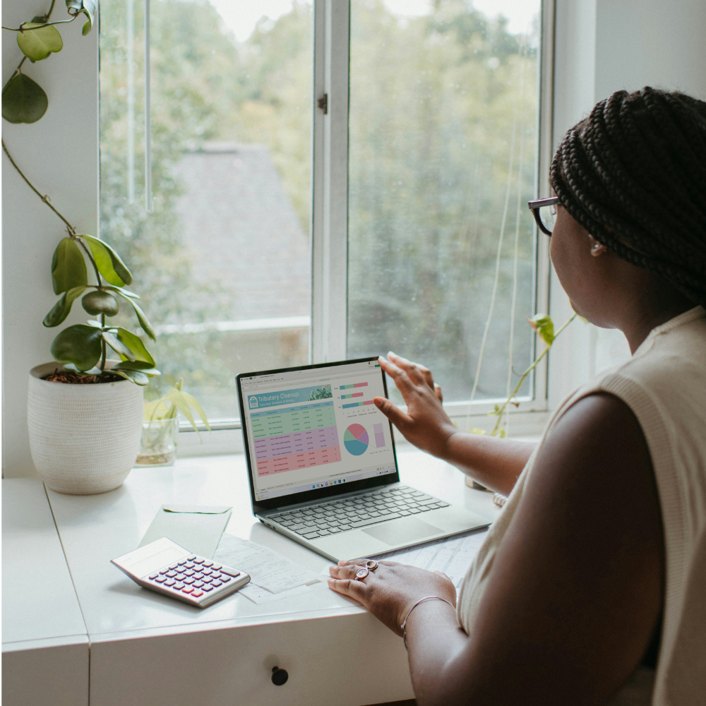 Business professional reviewing budgeting charts and financial forecasts on a laptop